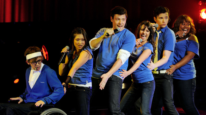 The cast of Glee performs in blue t-shirts and blue jeans