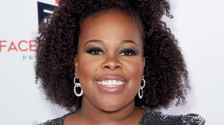 Amber Riley black hair afro hoop earrings, smiling