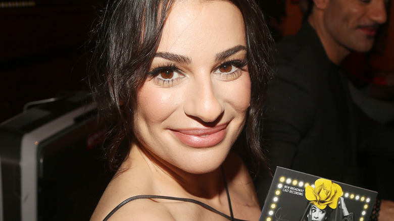 Lea Michele closed mouth smile wavy black hair neutral lip color