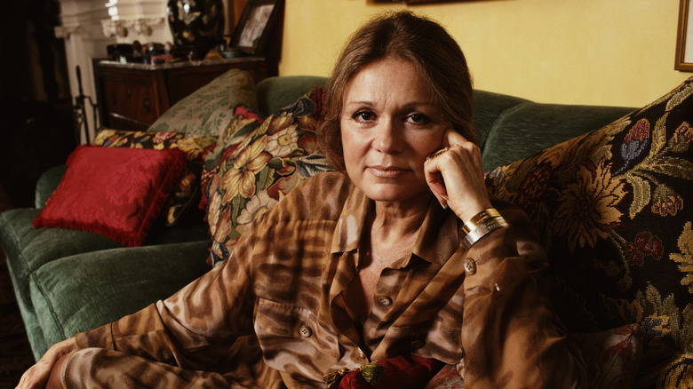 Gloria Steinem posing on a couch.