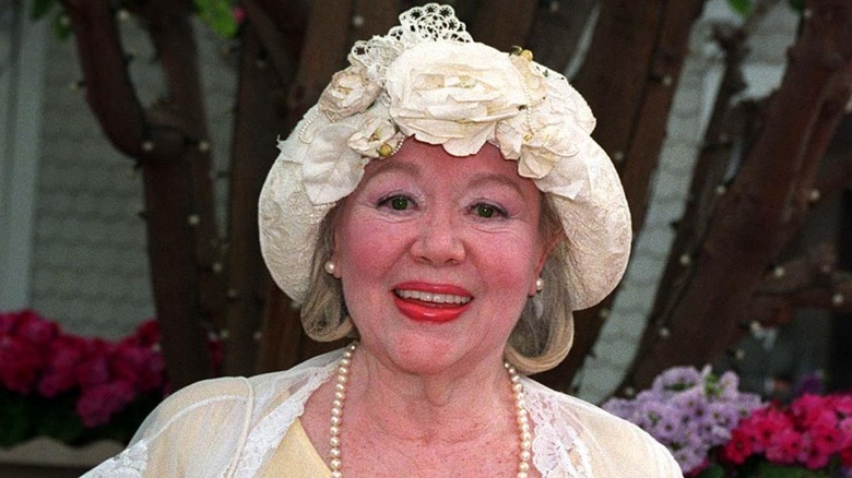 Glynis Johns posing in floral hat