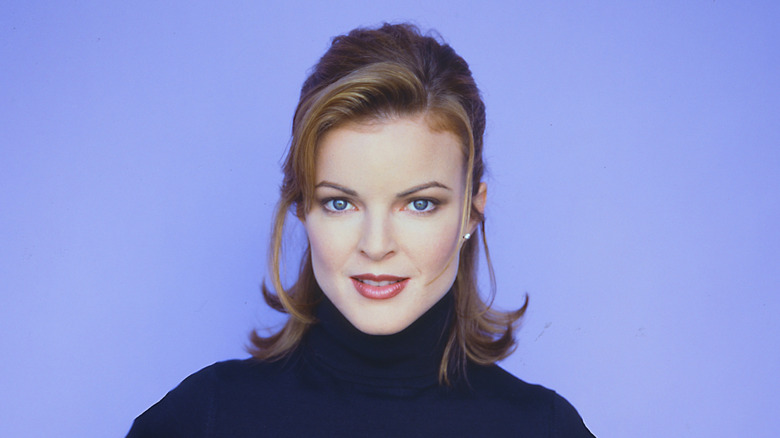 Marcia Cross posing against a purple background, circa 1984