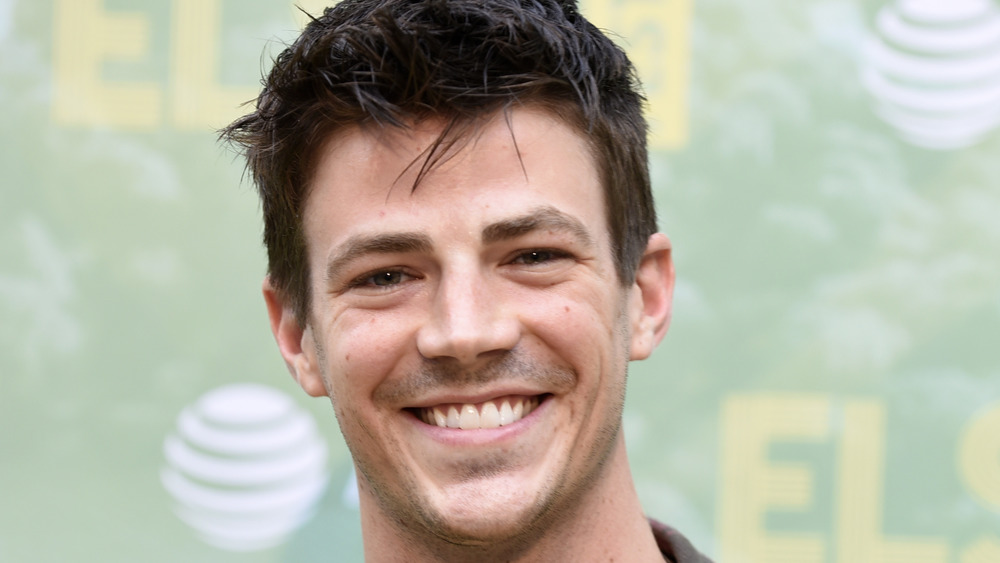 Grant Gustin smiling wide looking straight forward