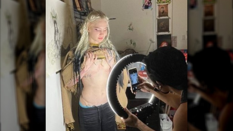 Grimes showing her chest tattoo