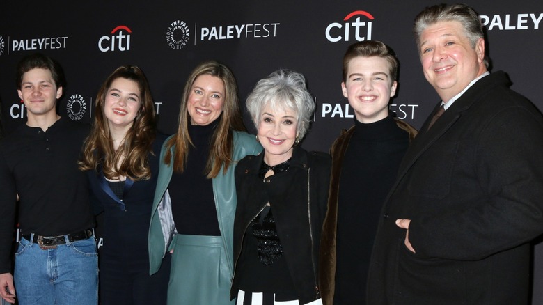 The cast of "Young Sheldon" stand close together and display wide smiles.