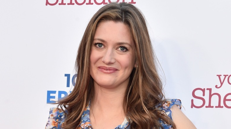 Sporting a floral dress, Zoe Perry smiles at the camera.