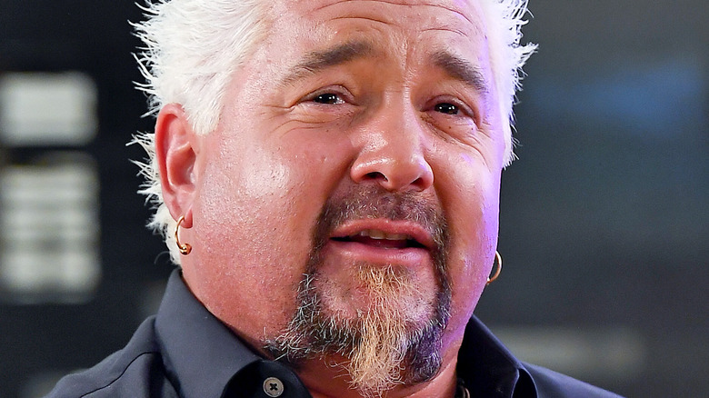 Guy Fieri giving a small smile