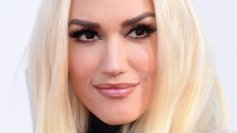 Gwen Stefani smirking and looking to the side