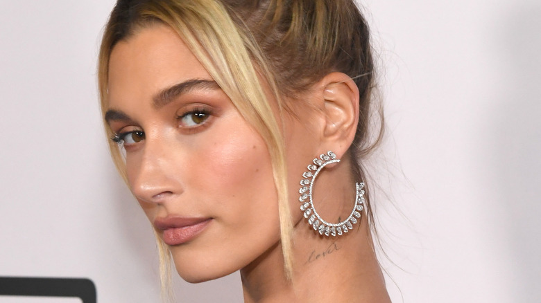 Hailey Bieber's "lover" tatttoo on her neck