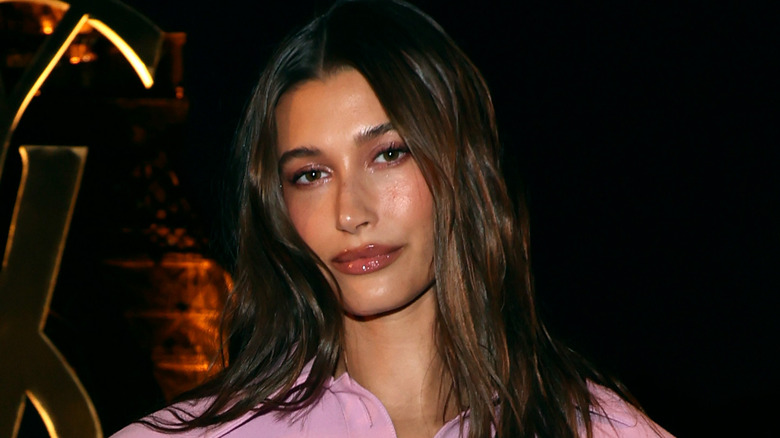 Hailey Bieber wearing pink, posing
