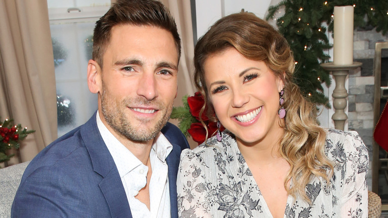 Andrew Walker and Jodie Sweetin sitting on couch