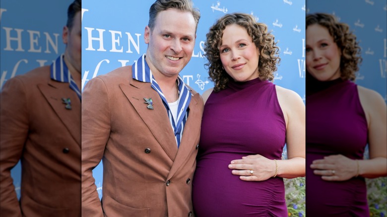 Ben Rosenbaum and Erin Krakow posing while she holds her belly