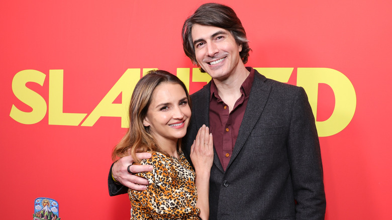 Rachael Leigh Cook posing with her hand on Brandon Routh's chest.