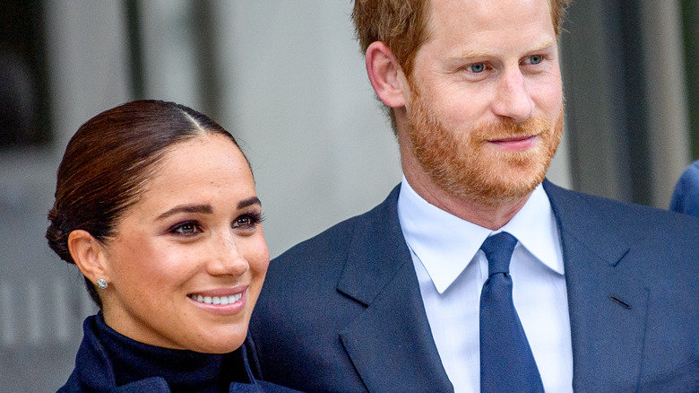 Prince Harry and Meghan Markle posingat an event 