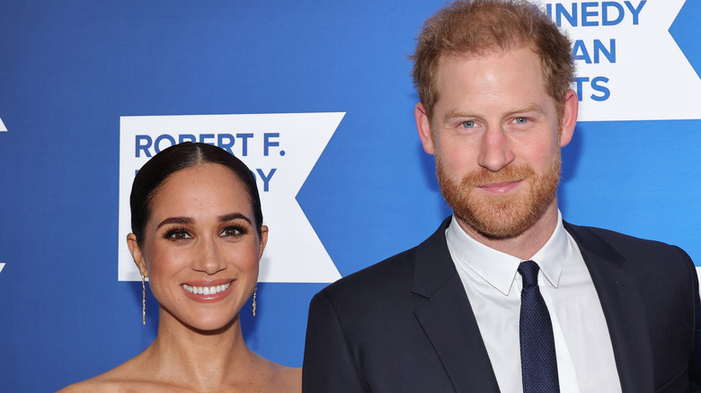 Prince Harry and Meghan Markle smiling in close-up at red carpet event