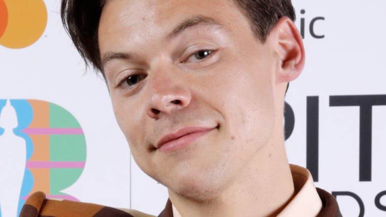 Harry Styles slicked back hair smiling