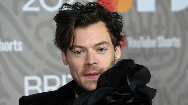Harry Styles messy hair black sweater
