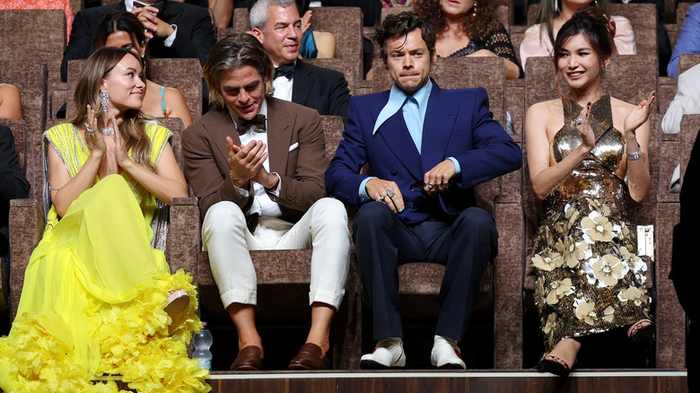Harry Styles seated next to Chris Pine