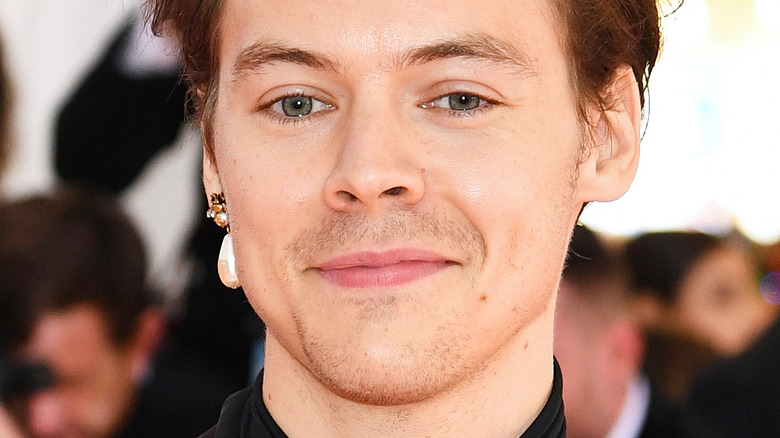 Harry Styles smiling on the red carpet