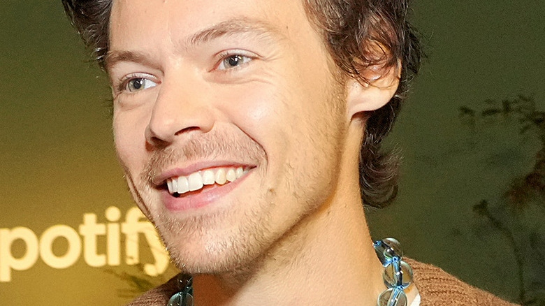 Harry Styles at a Spotify recording session, wearing a blue beaded necklace