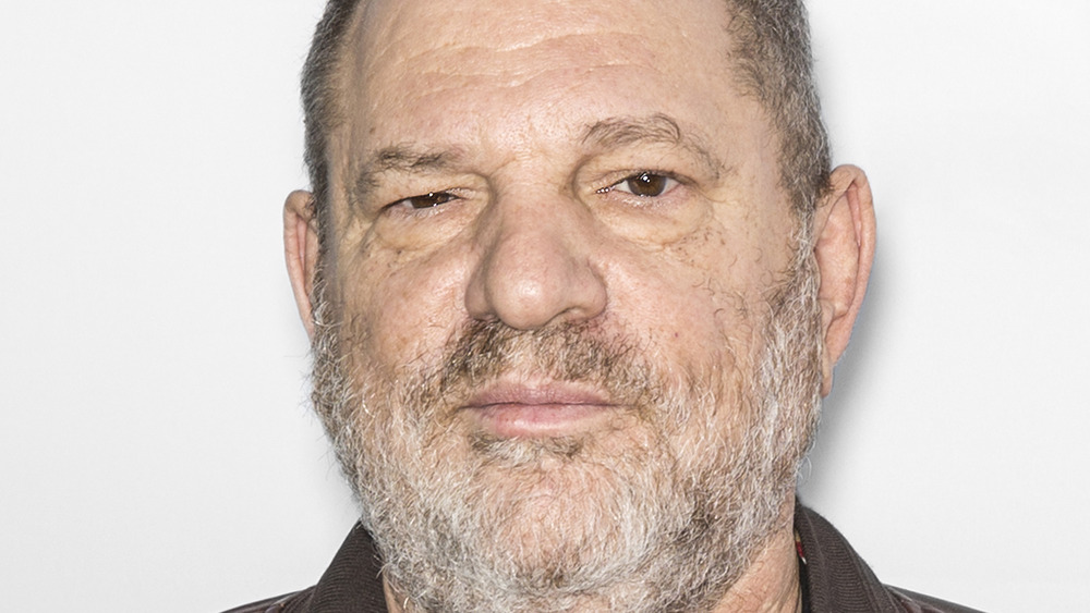 Harvey Weinstein poses 