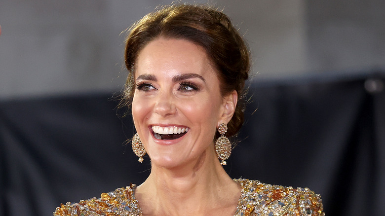 Kate Middleton smiling and looking up at an event