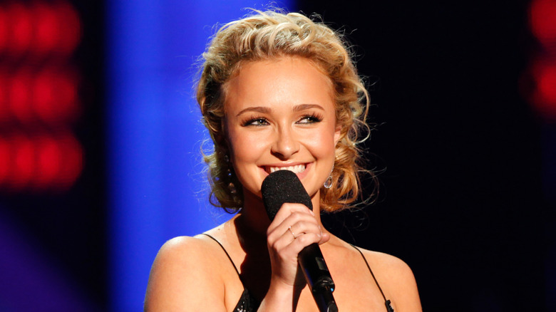 Hayden Panettiere smiling and holding microphone