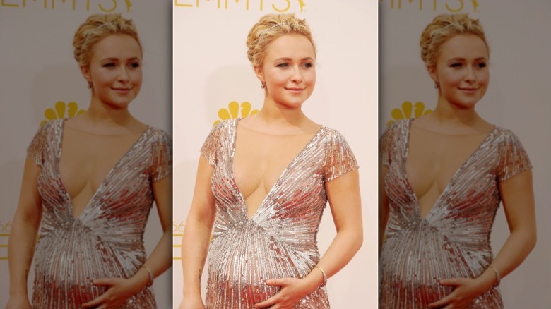 Hayden Panettiere puts a hand on her baby bump in 2014.