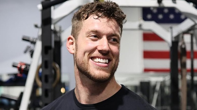 Clayton Echard posing in the gym