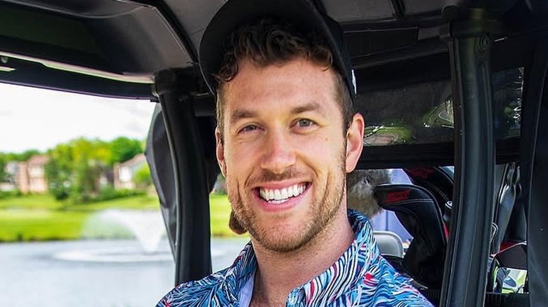 Clayton Echard posing for cameras in golf buggy