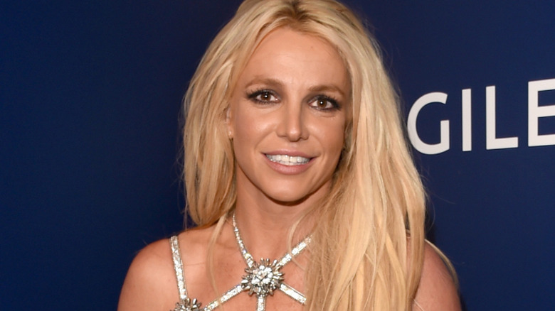 Britney Spears smiling and holding an award