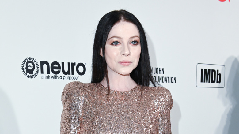 Michelle Trachtenberg posing in front of a white background
