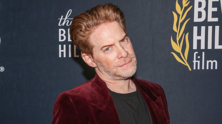 Seth Green posing in front of a blue background