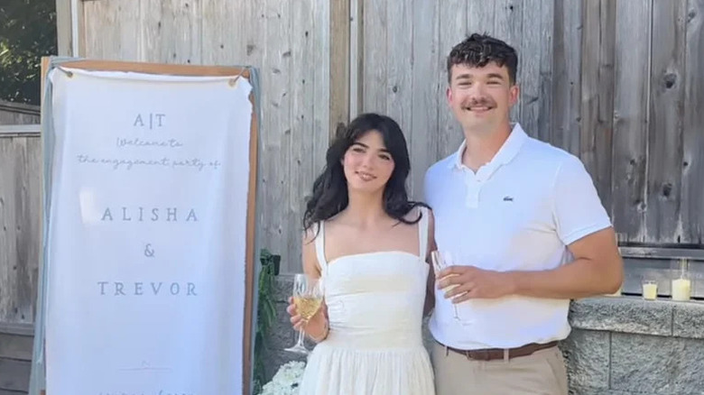 Alisha Newton and Trevor Best posing at engagement party