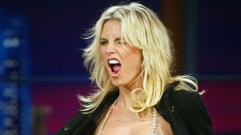 Heidi Klum opening coat to show off bra