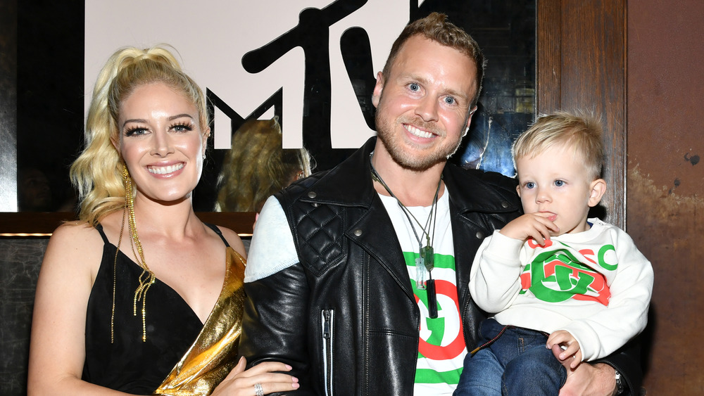 Heidi Montag, Spencer Pratt, and their son posing at an event 