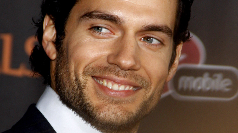 Henry Cavill smiles with a beard