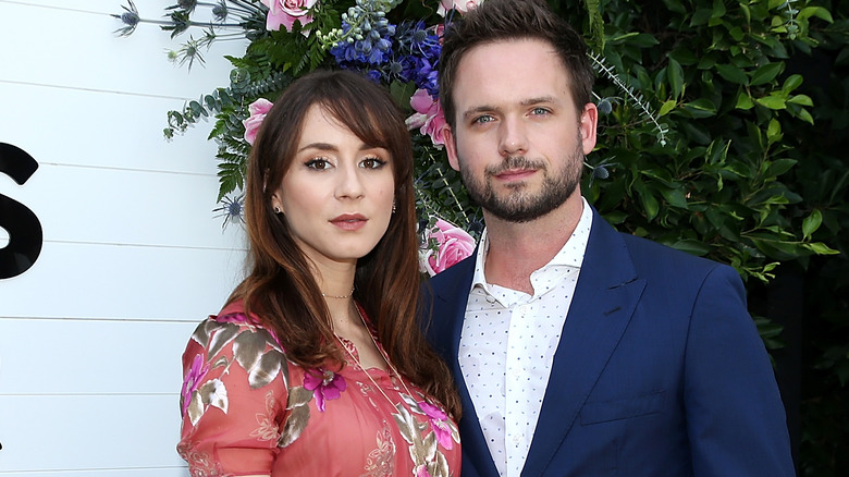 Troian Bellisario and Patrick J. Adams smiling