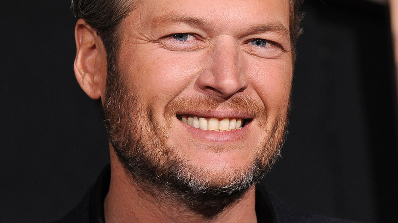 Blake Shelton smiles at an event