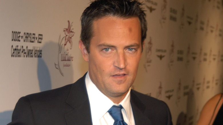 Matthew Perry wearing a suit