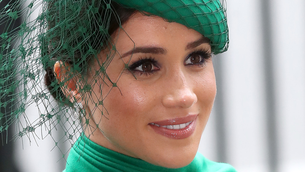 Meghan Markle wears a green headdress