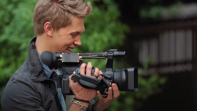 Austin Butler holding camera
