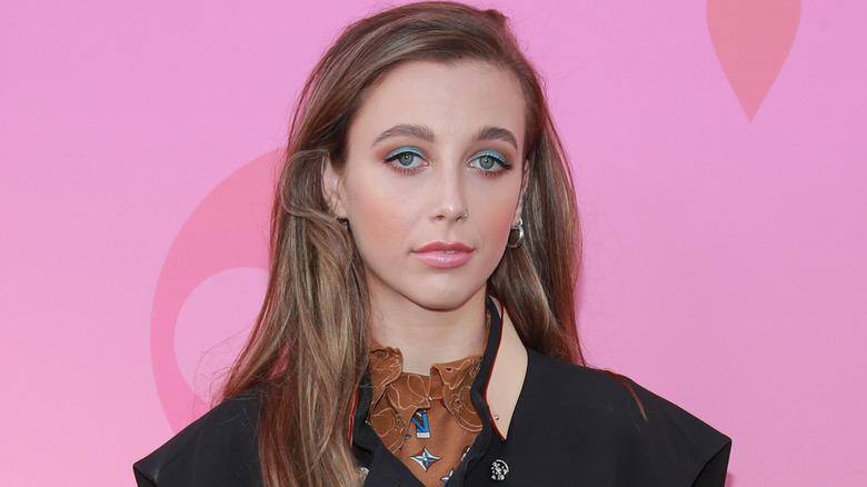 Emma Chamberlain in blue eyeshadow, posing