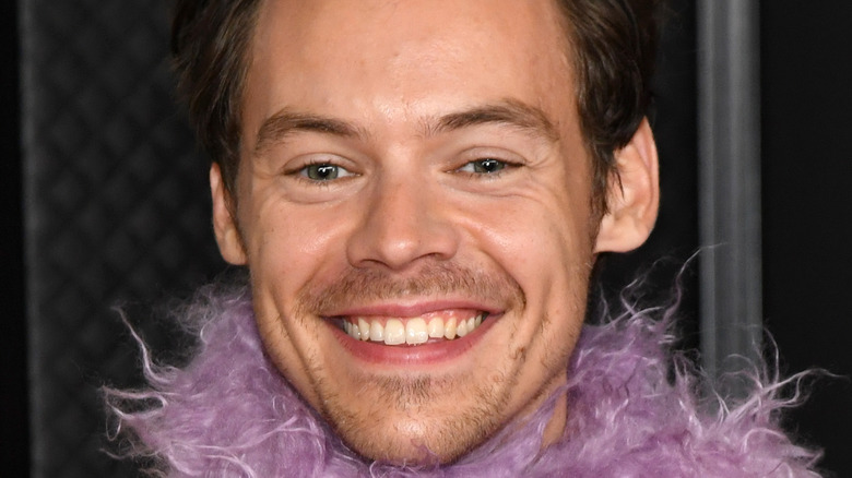 Harry Styles smiling at the 2021 Grammys