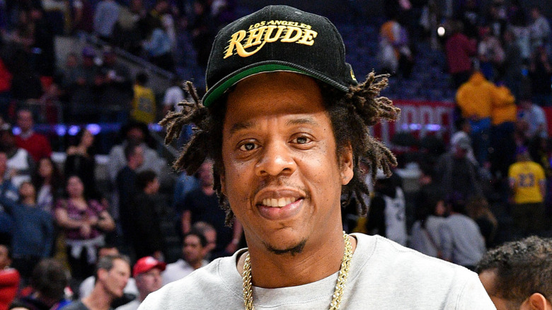 Jay-Z smiling at a basketball game