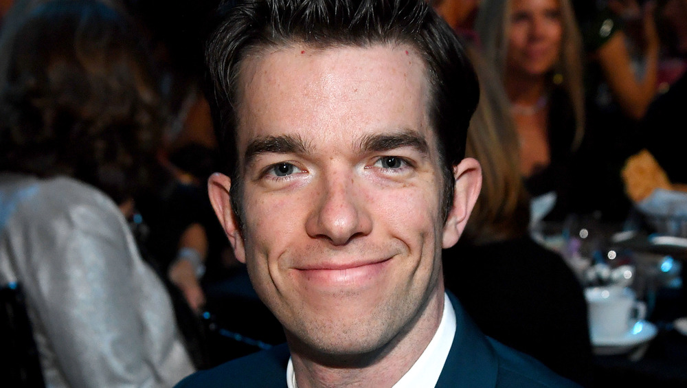 John Mulaney smiling at an event