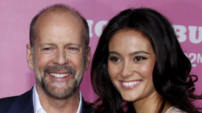 Bruce Willis with his arm around Emma Heming