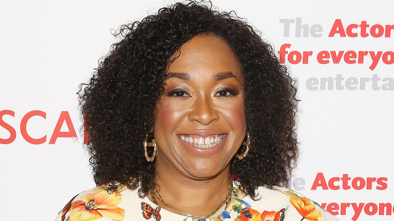 Shonda Rhimes wearing gold earrings