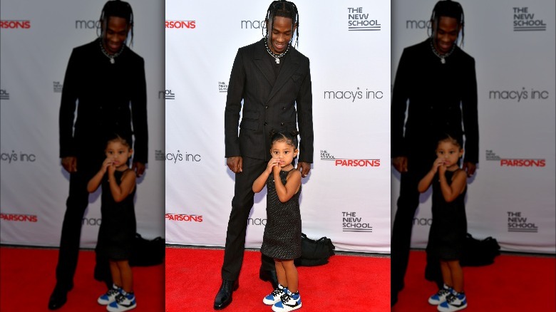 Travis Scott posing with daughter Stormi