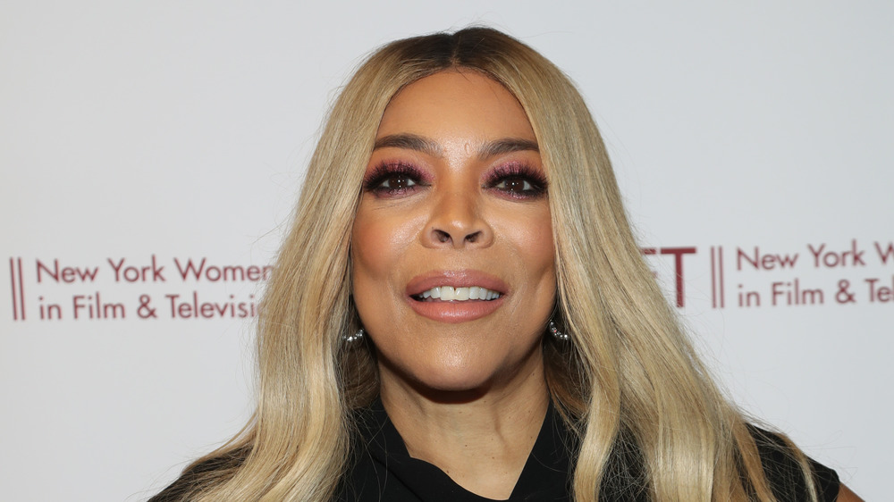 Wendy Williams smirks as she poses for a photo on the red carpet